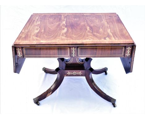 A Regency rosewood and brass inlaid sofa table, early 19th century, the drop end rectangular top above twin drawers, on a cen