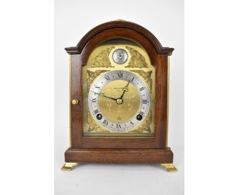 A Mid 20th century Elliott mantle clock retailed by Mappin &amp; Webb, the arched top brass dial having engraved decoration t