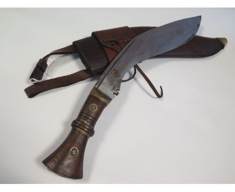 Kukri: An Indian copy of a WW1 Kukri. Spurious markings to blade. In its leather scabbard. 