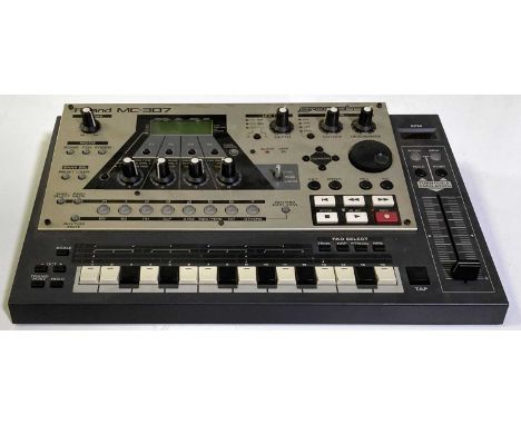 A Japanese made Roland MC-307 drum machine, with manual and power cable.