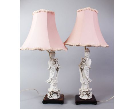 A PAIR OF 20TH CENTURY CHINESE BLANC DE CHINE KANGXI STYLE PORCELAIN FIGURAL LAMPS OF GUANYIN, The figures fitted for electri