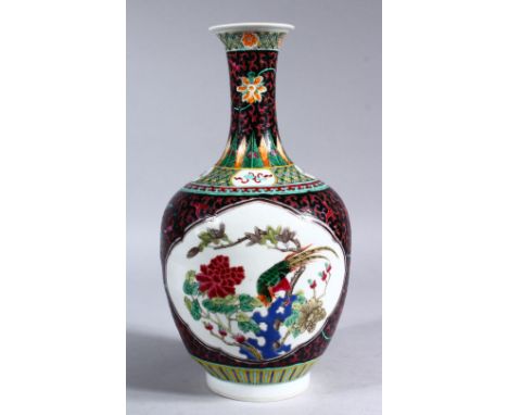 A 19TH / 20TH CENTURY CHINESE FAMILLE ROSE PORCELAIN BOTTLE VASE, the vase decorated with two panels upon a black ground with