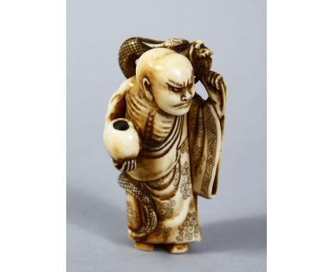 A GOOD JAPANESE MEIJI PERIOD CARVED IVORY NETSUKE OF CHINNAN SENNIN, the sennin stood in an upright position holding a beggar