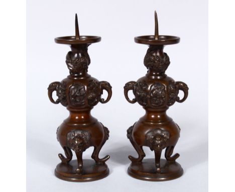 A PAIR OF 19TH CENTURY JAPANESE BRONZE ALTER PRICKET'S, with moulded elephant handles and feet, with smaller relief panels of