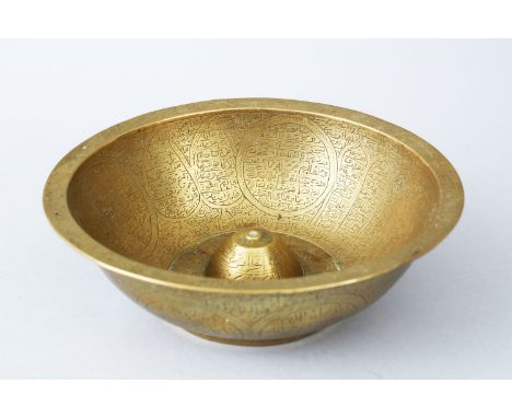 19TH CENTURY PERSIAN QAJAR ISLAMIC BRASS CIRCULAR "MAGIC" BOWL, with all over engraved decoration, 16cm diameter.