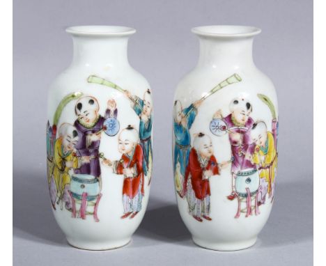 A PAIR OF EARLY 20TH CENTURY CHINESE PORCELAIN VASES OF BOYS, the body decorated with scenes o boys playing musical instrumen