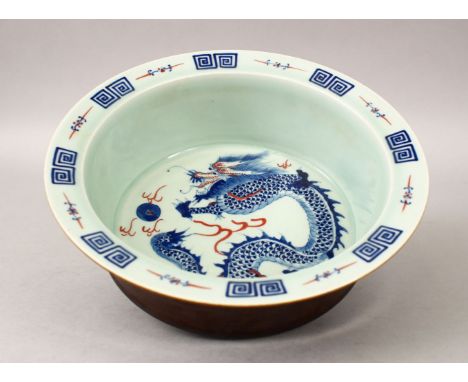 A 20TH CENTURY CHINESE BLUE &amp; WHITE PORCELAIN DRAGON BOWL, the bowls interior decorated with scenes of a four claw dragon