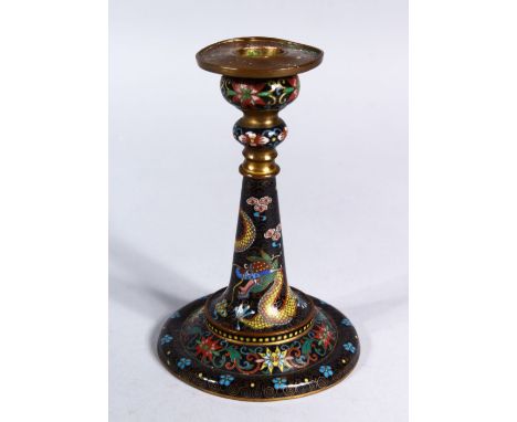 A GOOD 19TH CENTURY CHINESE CLOISONNE CANDLESTICK, decorated upon a black ground with scenes of a dragon amongst stylized clo