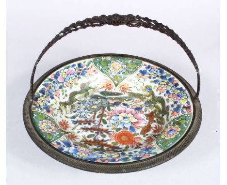 A 19TH CENTURY CHINESE FAMILLE ROSE / VERTE PORCELAIN PLATE WITH METAL MOUNTS, the plate with staple repair,decorated with sc