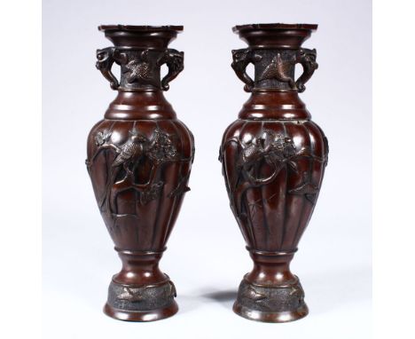 A PAIR OF JAPANESE MEIJI PERIOD BRONZE TWIN HANDLE VASES, the vases with decoration in relief depicting birds amongst trees ,