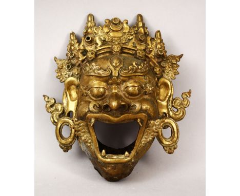 A 19TH CENTURY OR EARLIER CHINESE BRONZE FIGURE OF A MASK, the mythical face with its mouth open, 22cm x 20cm