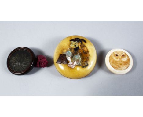 THREE GOOD JAPANESE MEIJI PERIOD CARVED IVORY &amp; WOOD AND METAL MANJU NETSUKES, The first a carved ivory roundel or button