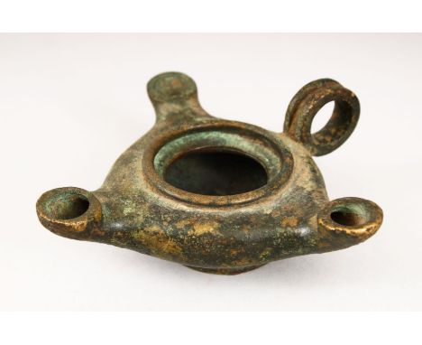 A CAST BRONZE TRIPLE SPOUT OIL LAMP, 15cm wide.