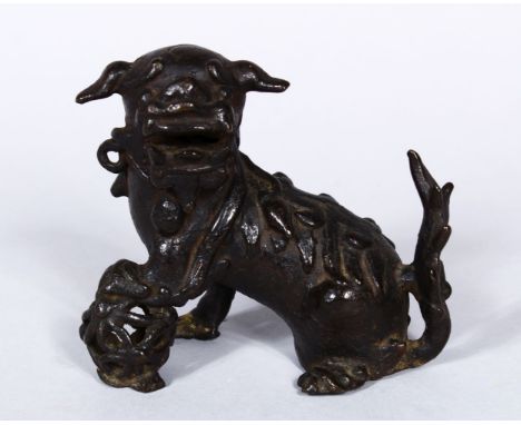 A GOOD EARLY CHINESE POSS MING BRONZE FIGURE OF KYLIN, in a seated position wwith his paw upon a ball, possibly ming dynasty,