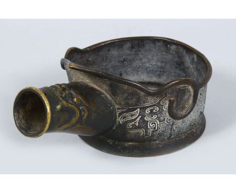 A GOOD EARLY CHINESE BRONZE SILK IRON, the body decorated with archaic design, 20cm wide.