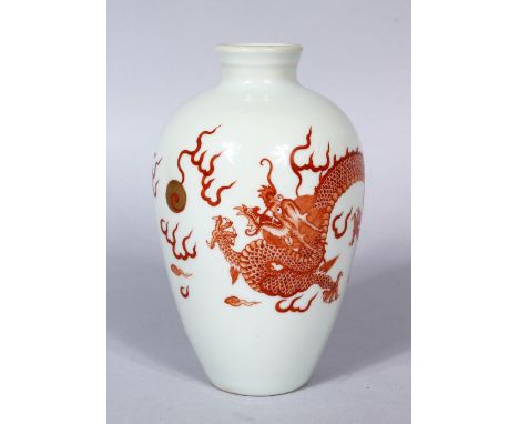 A 20TH CENTURY CHINESE IRON RED PORCELAIN DRAGON VASE, the body with a five claw dragon chasing the pearl, the pearl highligh