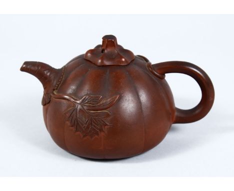 A GOOD 19TH / 20TH CENTURY CHINESE YIXING CLAY TEAPOT, in the form of a pumpkin, with relief decoration of foliage, 10cm high