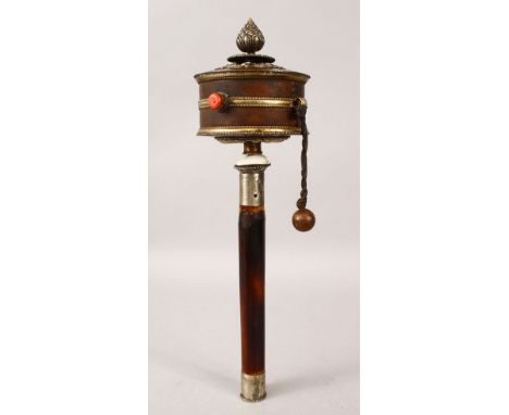 A 19TH CENTURY TIBETAN PRAYER WHEEL, the rotating wheel bound with leather and white metal mounts with a leather tie affixing