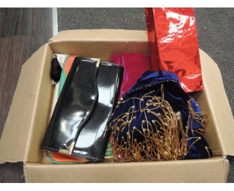 A selection of ladies vintage accessories including three handbags, two pairs of gloves, a feather boa, a beaded velvet shrug