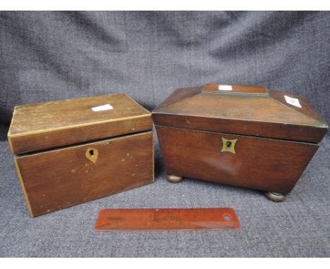 An early 19th century mahogany tea caddy of sarcophagus shape on bun feet, and a 19th century mahogany tea caddy of rectangul