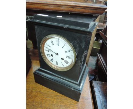 A late Victorian black slate mantel clock having circular Roman numerals dial  with striking movement