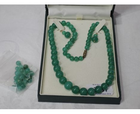A string of jade style graduated beads with matching drop bead earrings and spare beads