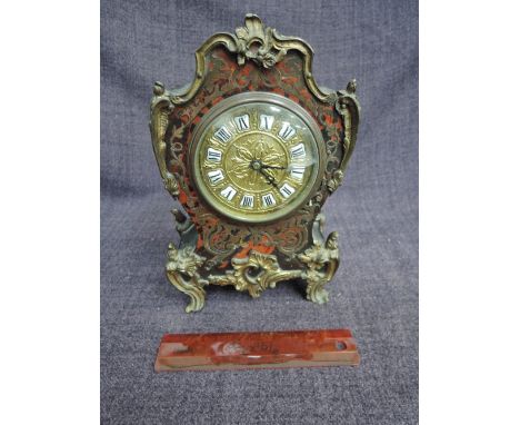 An early 20th century mantel clock of French boulle design, having shaped rococo case and ormolu style applique