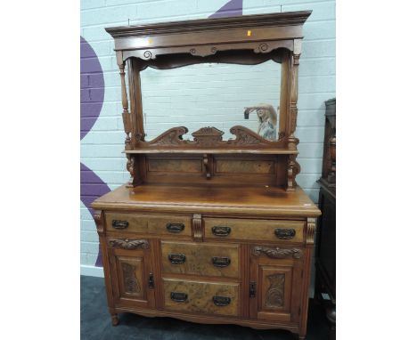 A late Victorian walnut and mahogany full height sideboard having raised pillar mirror back with Swan neck and shelf, over tw