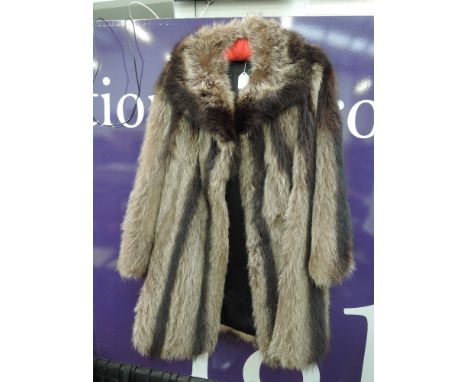 A lady's vintage Canadian racoon fur coat having wide collar and leather trim to lining