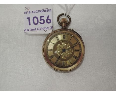A small yellow metal top wound pocket watch stamped 14K having a Roman numeral dial to engine turned face in an extensively e