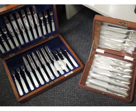 An oak canteen containing a set of 12 silver plated fruit knives and forks having mother of pearl handles, retailed by Fattor