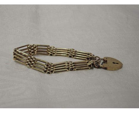 A 9ct gold four bar gate bracelet of traditional form having padlock clasp, approx 24.7g