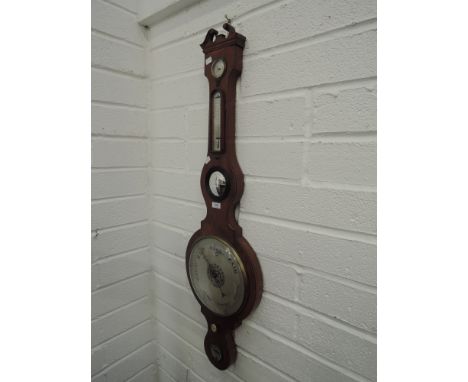 An early 19th century mahogany wheel barometer having later swan neck with humidity and thermometer scale and level