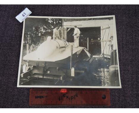 A vintage 1930's press photograph showing Malcolm Campbell and team on Bluebird K4, at Coniston 1939, signed by Malcolm Campb