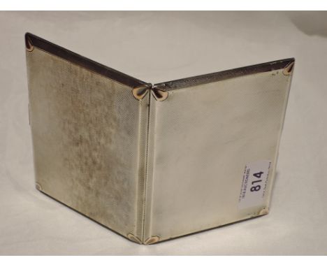 A silver cigarette case having engine turned decoration and rose metal detail, Birmingham 1932,  Walker & Hall,  approx 198.5