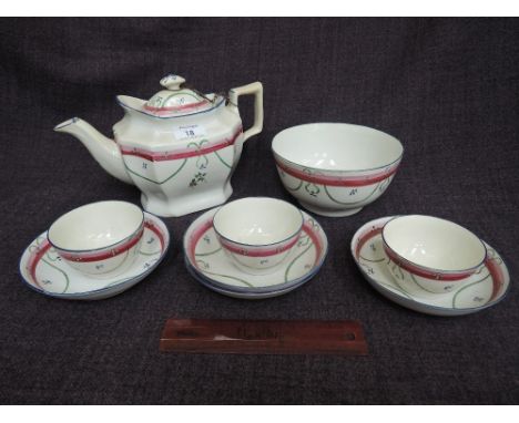 An early 19th century porcelain part tea service having painted floral decoration, number 85 to base