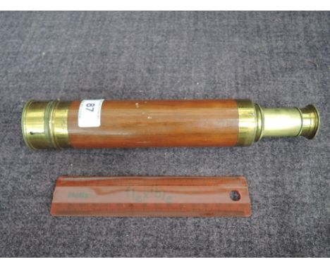 A vintage brass telescope having mahogany sheath