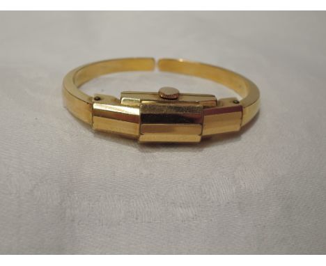 A lady's vintage gold plated bangle watch by Marvin having Arabic and baton numeral dial to rectangular face with cover and s