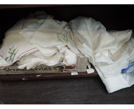 A box of vintage table cloths,tray cloths and other table linen,some having embroidery, all are in a variety of styles and si