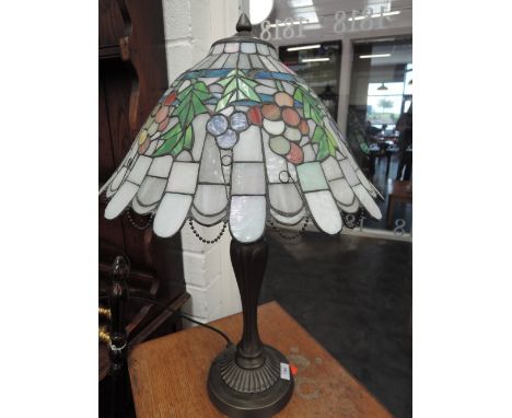 A modern Tiffany style table lamp having chain and drop glass shade on shaped base