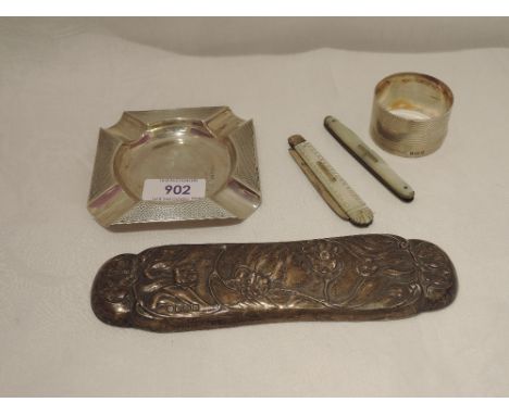 A small selection of HM silver including an ashtray, napkin ring, Edwardian clothes brush back, Victorian folding fruit knife