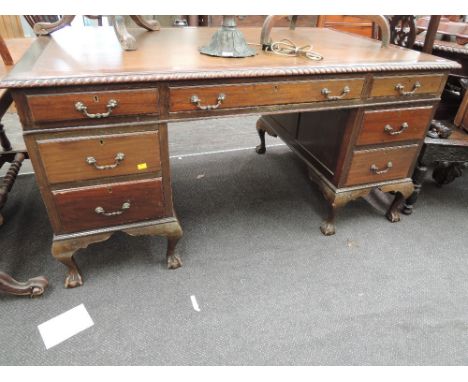 An early 20th century mahogany desk in the Chippendale revival style having inset top  with frieze and pedestal drawers on ca