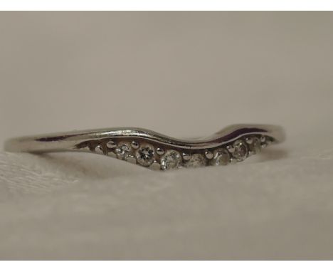 A lady's wish bone wing having 7 diamond chips on a 9ct white gold loop,  size K/L