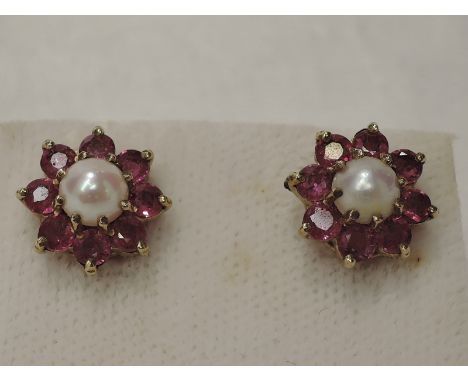 A pair of ruby and pearl cluster stud earrings on 9ct gold mounts