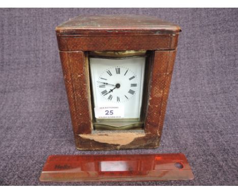 An early 20th century brass French carriage clock of traditional four glass design, on bun feet, in fitted caseNOT TESTED FOR