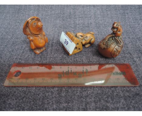 Two traditional style treen netsukes rat and cheese, and rat on apple, signed and a resin netsuke, Mr Mole