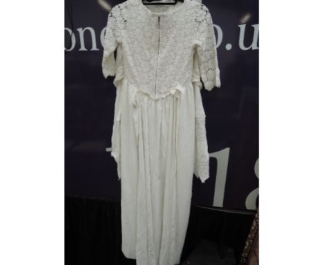 A vintage wedding dress by Emenson having a lace covered bodice, 3/4 sleeves and a train, approx size 8, two cotton underskir