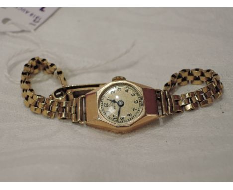 A lady's 9ct gold vintage wrist watch by Record having Arabic numeral dial to small face on a 9ct gold bracelet strapWeight 1