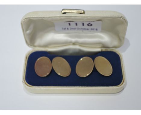 A pair of 9ct gold cufflinks of oval form having engine turned decoration and chain connectors, approx 6g