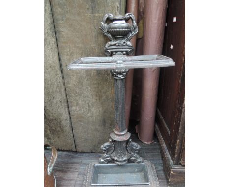 A traditional cast iron stick stand of architectural design